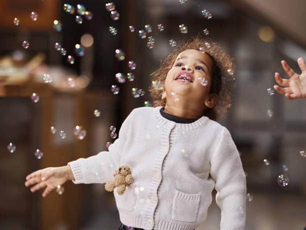 istock Happy black girl among bubbles at home. 2170126636