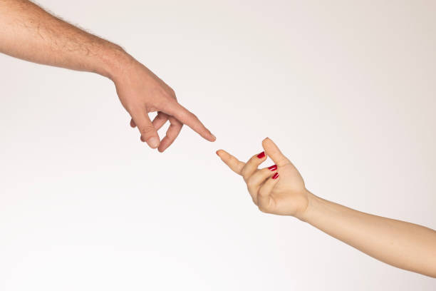 Hands of two people reaching for each other