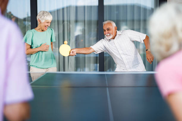 istock Playful seniors having fun while playing table tennis. 2170129608