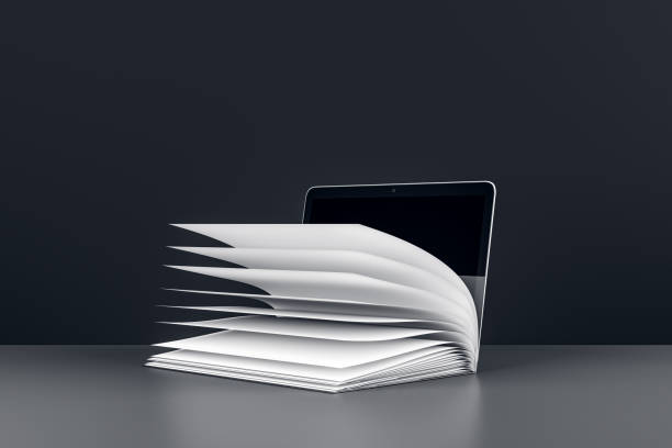 Open book with pages turning in front of a laptop on a grey surface. 3D Rendering
