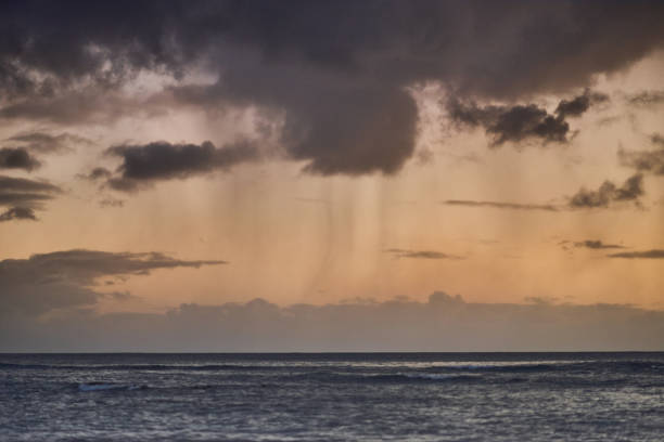 istock Beautiful clouds with rain during sunset over the ocean 2170131510