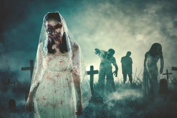 istock Halloween horror concept. Group of spooky ghosts standing on the burning graveyard. Shot at night time 2170131609