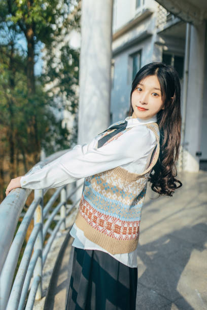 istock A beautiful woman is in the campus corridor 2170132611
