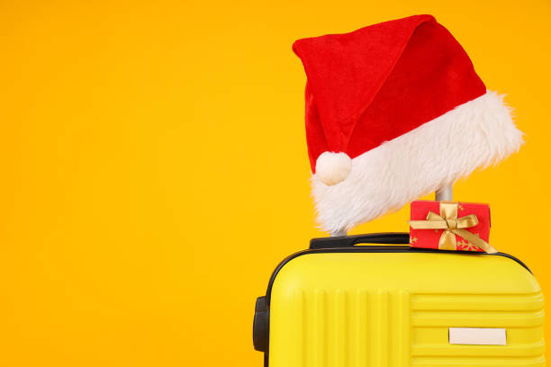 istock A suitcase with a New Year's hat and gifts 2170132847