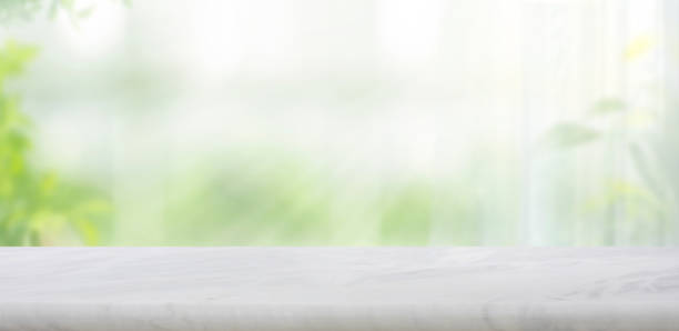 istock Selective focus.Elegance product display background with marble top on blur big window and fresh garden. 2170133083