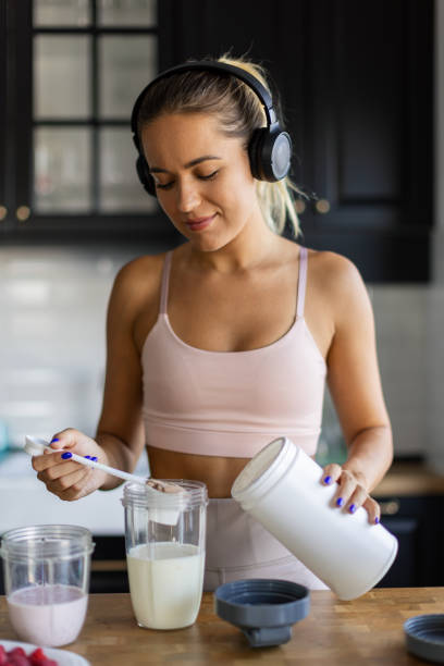 istock Sportswoman preparing smoothie in her kitchen 2170135242