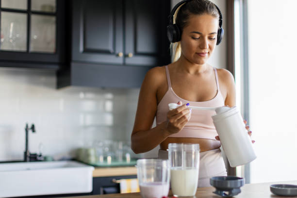 istock Sportswoman preparing smoothie in her kitchen 2170135245