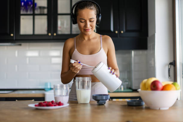 istock Sportswoman preparing smoothie in her kitchen 2170135246