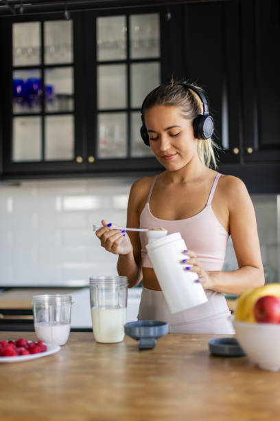 istock Sportswoman preparing smoothie in her kitchen 2170135250