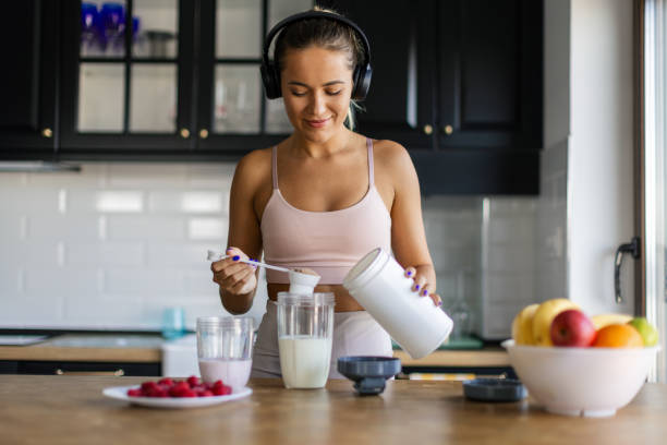 istock Sportswoman preparing smoothie in her kitchen 2170135252