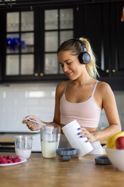 istock Sportswoman preparing smoothie in her kitchen 2170135267