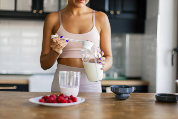 istock Sportswoman preparing smoothie in her kitchen 2170135277