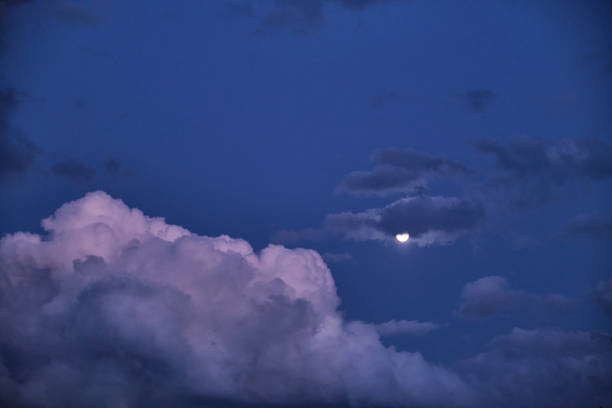 istock Night dark blue sky with fluffy clouds and round moon 2170135324
