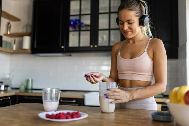 istock Sportswoman preparing smoothie in her kitchen 2170135419