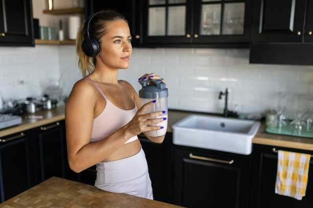 istock Sportswoman drinking smoothie in the kitchen 2170135448