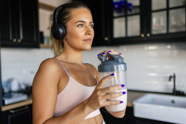 istock Sportswoman drinking smoothie in the kitchen 2170135458