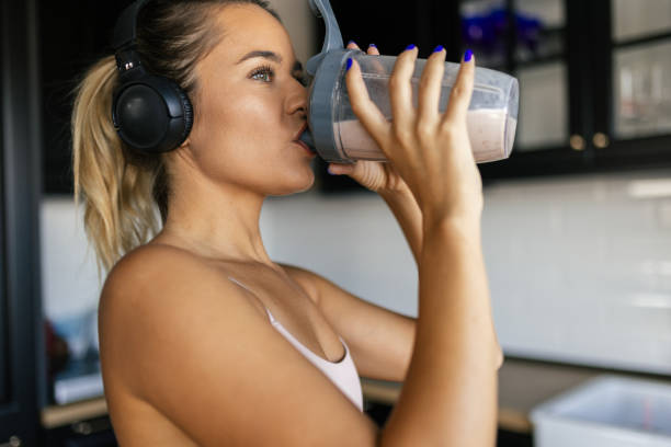 istock Sportswoman drinking smoothie in the kitchen 2170135460