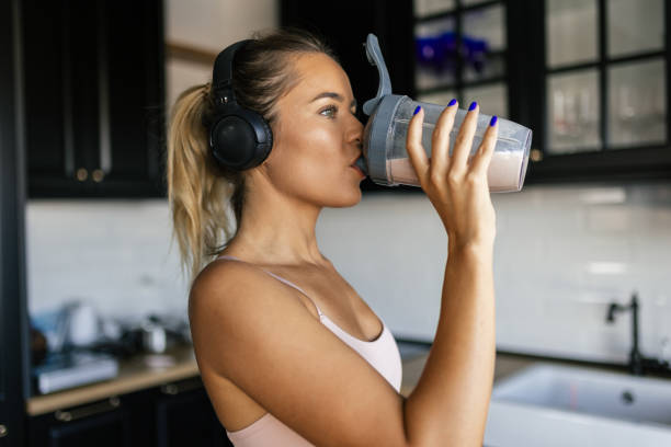 istock Sportswoman drinking smoothie in the kitchen 2170135463
