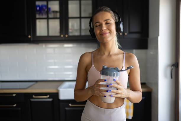 istock Sportswoman drinking smoothie in the kitchen 2170135474
