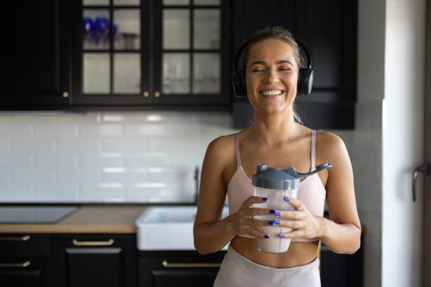 istock Sportswoman drinking smoothie in the kitchen 2170135477