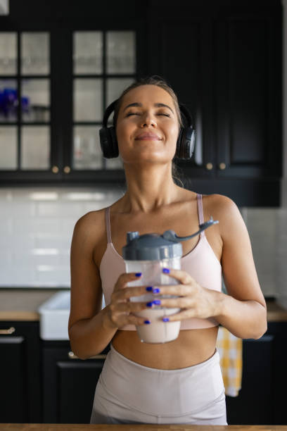 istock Sportswoman drinking smoothie in the kitchen 2170135496