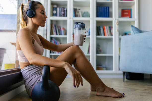 istock Sportswoman drinking protein drink after exercise 2170135520