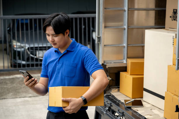 istock The delivery man is calling the customer to make the delivery. 2170135988