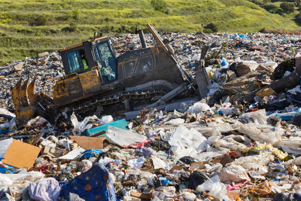 istock Heavy machinery shredding garbage in an open air landfill. Pollution 2170136211