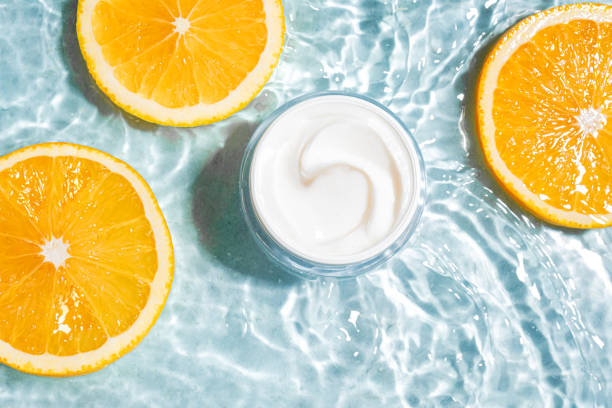 Vitamin C cream in clear water with orange citrus