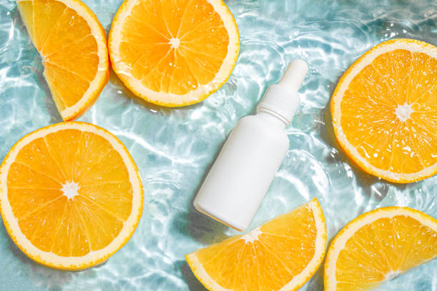 istock White serum bottle and oranges in water 2170136976