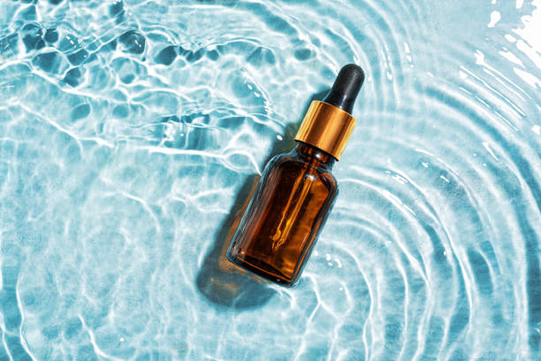 istock Bottle of face serum in blue water 2170137743