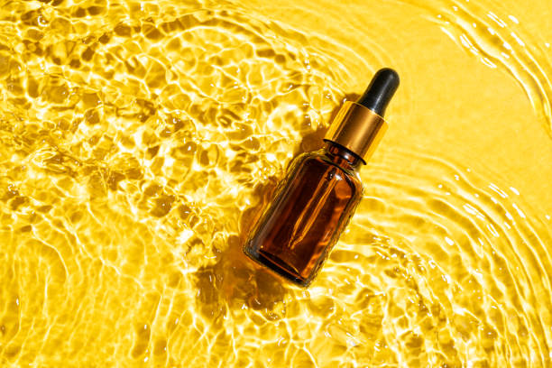 istock Retinol serum bottle in yellow water 2170137761