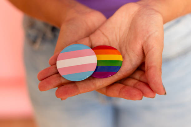 istock Woman holding transgender pride and rainbow badges 2170141065