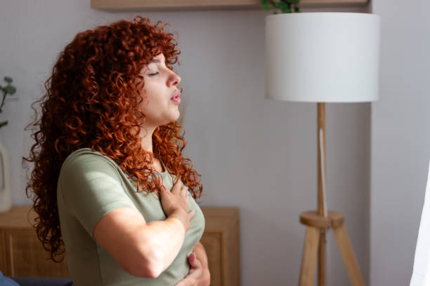 istock Redhead woman practicing deep breathing exercise at home 2170141259