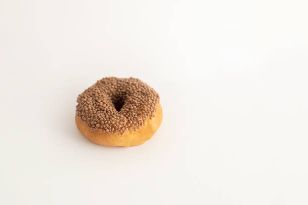 istock donut with sprinkles on a light background, sweet pastries, donut day, fat thursday 2170141276