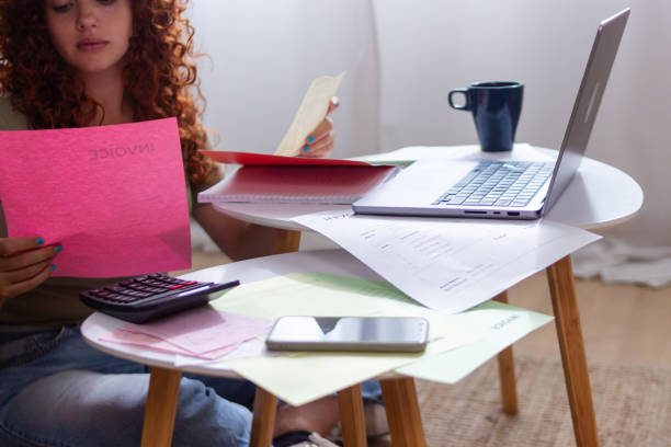 istock Young freelancer woman working from home checking invoices and bills 2170141308