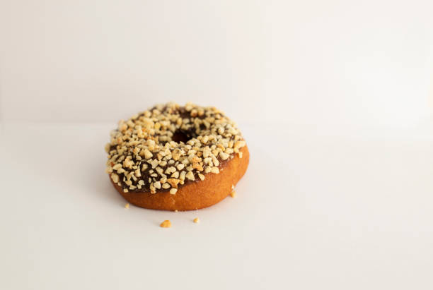 donut with sprinkles on a light background, sweet pastries, donut day, fat thursday