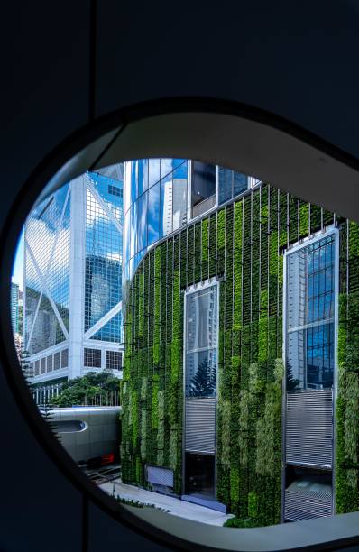 istock View of modern buildings with a green wall from a circular window. 2170141812