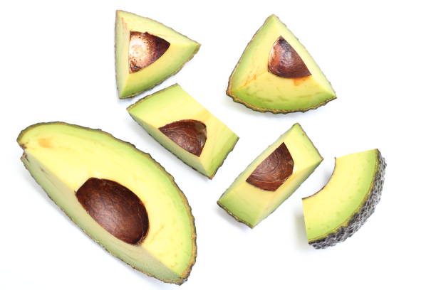 Avocado halves on wooden
