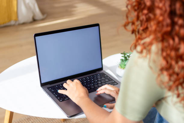 istock Woman working from home using laptop with blank screen 2170145127