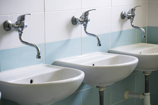 istock Hostel washroom with white ceramic washbasins. 2170145502