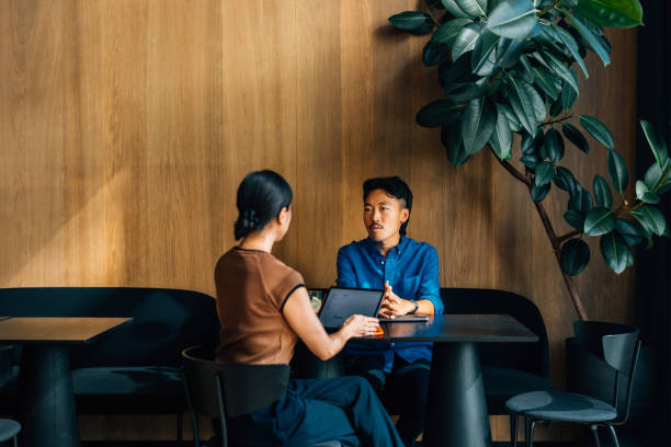 istock Colleagues Engaged in a Business Meeting at a Modern Cafe 2170146464
