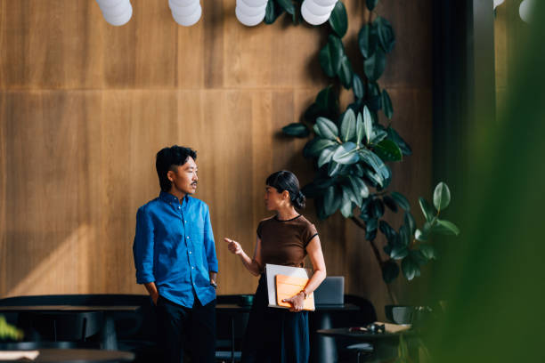 istock Casual Colleagues Discussing Project in Modern Office Space 2170146477