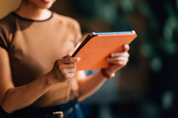 Woman Holding a Tablet Device in Casual Setting