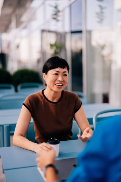 istock Friendly Conversation at Outdoor Cafe with Coffee 2170146505