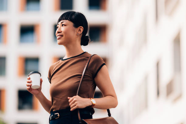 Confident Woman Enjoying Coffee On A Bright Urban Day
