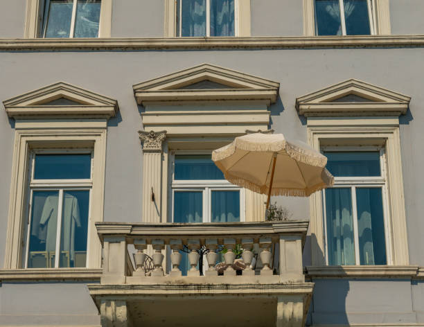 architectural pattern, typical german balconies with yellow parasol and geranium