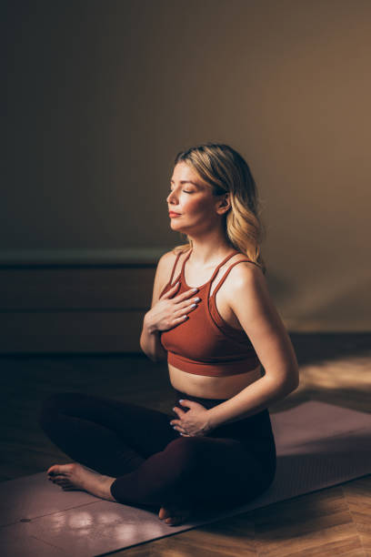 Woman Practicing Meditation and Mindfulness on Yoga Mat