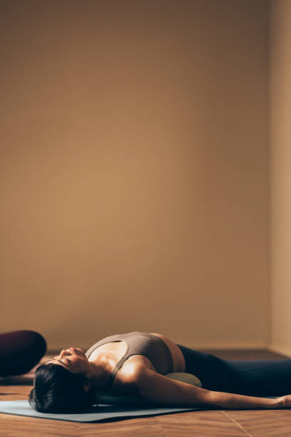 istock Woman Practicing Relaxation Yoga Pose on Exercise Mat 2170148066