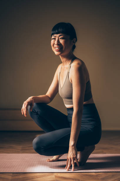 istock Smiling Woman Posing Calmly on Yoga Mat During Workout 2170148094
